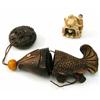 Image 1 : An ivory netsuke, figure crouching within helmet shaped hut (1.5in.) and a carved wood netsuke an...