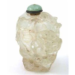 A Chinese rock crystal snuff bottle, carved with a buffalo rider on a mountain path, 2.5ins...