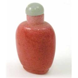 A Chinese pink speckled glass snuff bottle, with jade stopper, 2.75ins...