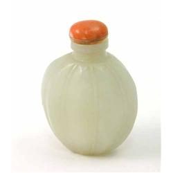 A Chinese pale jade snuff bottle, of fluted ovular form, with coral stopper, 2.25ins...