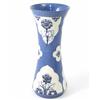 Image 1 : A Moorcroft powder blue vase, of waisted cylindrical form, decorated with shaped panels of forget...