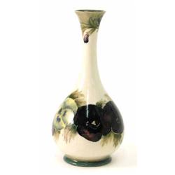 A Moorcroft 'Pansy' vase, decorated in shades of blue, red, green and yellow against a cream grou...