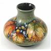 Image 1 : A Moorcroft 'Leaf and Berry' flambe squat vase, decorated in shades of blue, green, yellow and oc...