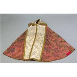A 19th century deep pink woven silk damask semi-circular ecclesiastical cope, with ivory silk dam...