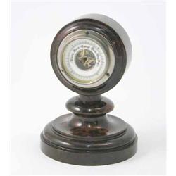 An Edwardian serpentine desk top barometer, with white enamelled 2 ins diameter dial and exposed...