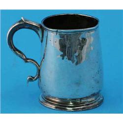 An 18th century silver pint mug, with engraved motto and scroll handle, marks worn, dented, 4.25i...