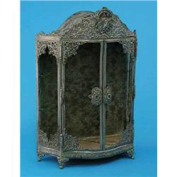 A French plated miniature model of an armoire, decorated throughout with rococo style motifs on s...