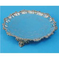 A Victorian silver salver, with shell and scroll border, engraved decoration and scroll feet, mak...