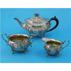 A Victorian three piece silver tea set, of shaped oval form, decorated throughout with engraved a...