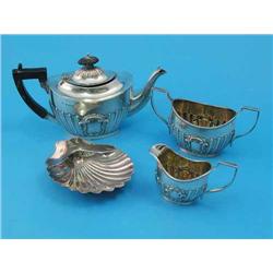 A George V three piece silver bachelors tea set, of oval form with demi-fluted decoration, Birmin...