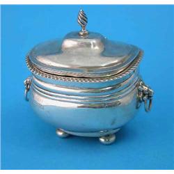 An Edwardian silver tea caddy, with gadrooned rim, twin lion mask loop handles and bun feet, Ches...