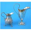Image 1 : A George II silver cream jug, with scroll handle, decorated with engraved and repousse rococo scr...