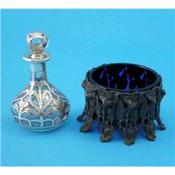 A silver overlaid clear glass scent bottle and stopper, and a base metal salt with blue glass lin...