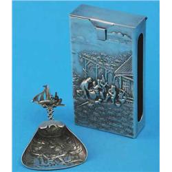 A Danish white metal caddy spoon, with ship finial and decorated with figures in an interior and...