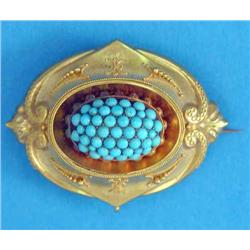 A Victorian oval brooch, with bead and wirework decoration, the central boss pave set turquoises,...