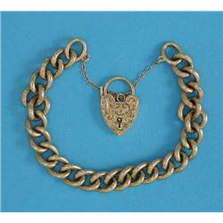 A 9ct gold curb link bracelet, with engraved padlock clasp, 44.5grms...