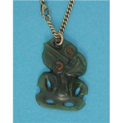 A Maori carved nephrite Hei-tiki pendant, on a 9ct gold curb link chain...