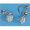 Image 1 : A pair of opal and diamond drop earrings, each claw-set in white gold with an oval opal in a bord...