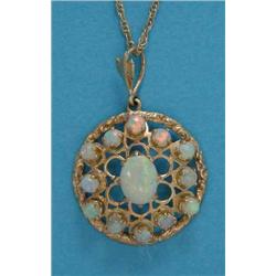 A gold openwork circular pendant, set with a central oval opal bordered by 12 round opals, on fin...