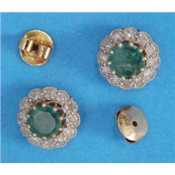 A pair of gold, emerald and diamond circular cluster earrings, each with a claw-set emerald in a...