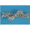 Image 1 : A 1930's platinum and diamond brooch, designed as a loosely tied ribbon, 2.25ins...