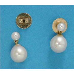 A pair of cultured pearl earrings, each with a round pearl suspended on a smaller pearl...