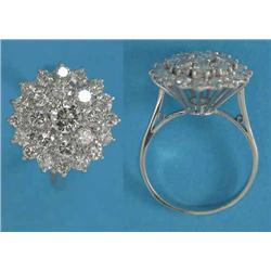 A white gold diamond set circular cluster ring, set 25 brilliant-cuts, the centre stone approxima...