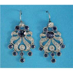 A pair of sapphire and diamond pendant earrings, of pierced stylised flowerhead design, each mill...