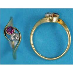 An 18ct gold 2-stone cross-over ring, set with a pink sapphire and an old brilliant cut diamond...