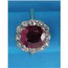 Image 1 : An 18ct gold ruby and diamond cluster ring, the cushion shaped ruby in a border of 12 diamonds...