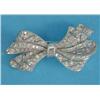 Image 1 : A diamond bow brooch, of piercework design set brilliant and baguette cut diamonds, 1.75ins...