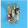 Image 1 : A triple band gold ring, set with a ruby, sapphire and diamonds...