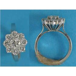 An 18ct white gold 9-stone diamond flowerhead cluster ring, the centre stone approximately .5ct...