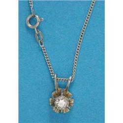 A solitaire diamond pendant, on a fine curb link white gold chain...