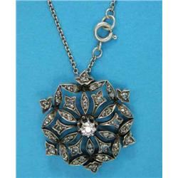 An Edwardian diamond set hexagonal openwork pendant, of foliate design in gold and silver mount...