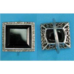 A platinum Art Deco ring, set with a rectangular cut onyx within a border of small diamonds...