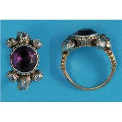A 19th century 18ct gold ring, set with a round-cut amethyst flanked by 6 old cut diamonds, the 2...