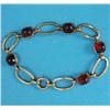 Image 1 : A 9ct gold flexible bracelet, designed as 6 oval open links alternating with 5 square cut carneli...