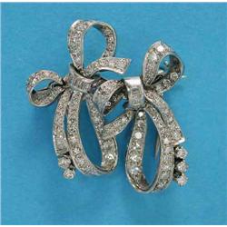 A white gold diamond set double bow brooch/dress clip, each bow set square and old cut diamonds...