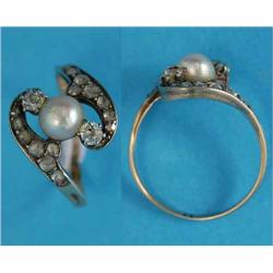 An 18ct gold cross-over ring, set with a cultured pearl flanked by 2 diamonds, the shoulders set...