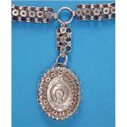 A late Victorian silver pendant locket, the front embossed with a horseshoe, on a matching collar...