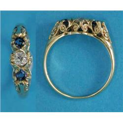 An 18ct gold 3-stone ring, claw-set with a central diamond flanked by sapphires...