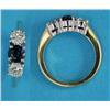 Image 1 : An 18ct gold and platinum 3-stone ring, claw-set with a round-cut central sapphire and flanked by...