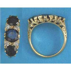 A Victorian design 18ct gold 3-stone sapphire ring, the round-cut sapphires spaced by pairs of di...