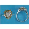 Image 1 : An 18ct white gold diamond ring, claw-set with a heart shaped diamond bordered by 12 round-cut ye...