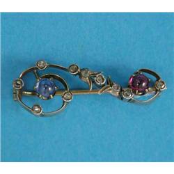 An Edwardian gold love token brooch, designed as a question mark set with cabochon sapphire, ruby...