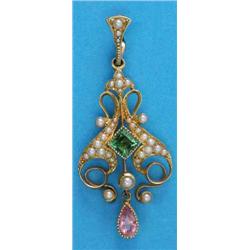 An Edwardian 15ct gold pendant, of open scroll design set with a square-cut green tourmaline and...