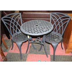 TABLE WITH TWO CAST IRON CHAIRS.