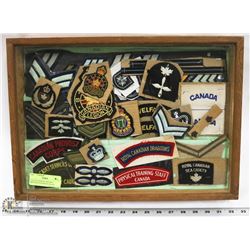 COLLECTION OF VINTAGE MILITARY PATCHES IN GLASS