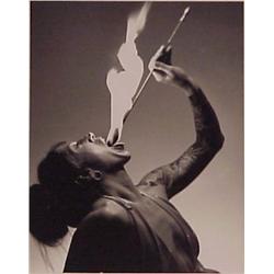 Rick Rusin (20th Century) American, THE FIRE EATER, black & white photo, 9 ½ x 7 ½”, signed on...